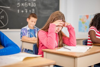 young girl in class, experiencing anxiety