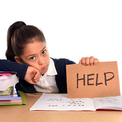 school child with "help" sign