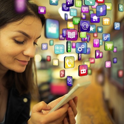 woman selecting apps on her mobile device