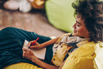 woman jotting some notes and feeling grateful