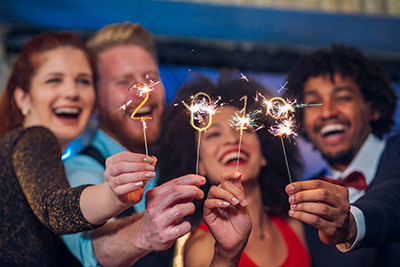 people celebrating New Years Eve with sparklers