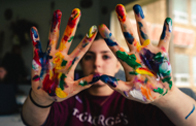 Hands covered in colorful paint