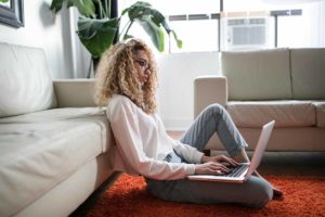 woman participating in remote telehealth therapy session.