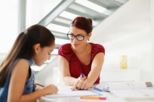 Woman teaching girl