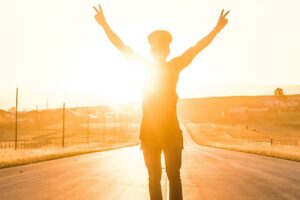 Person in sun on the road