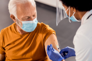 man getting injection from health professional